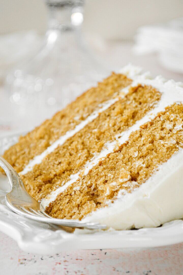A slice of cardamom cake with eggnog buttercream.