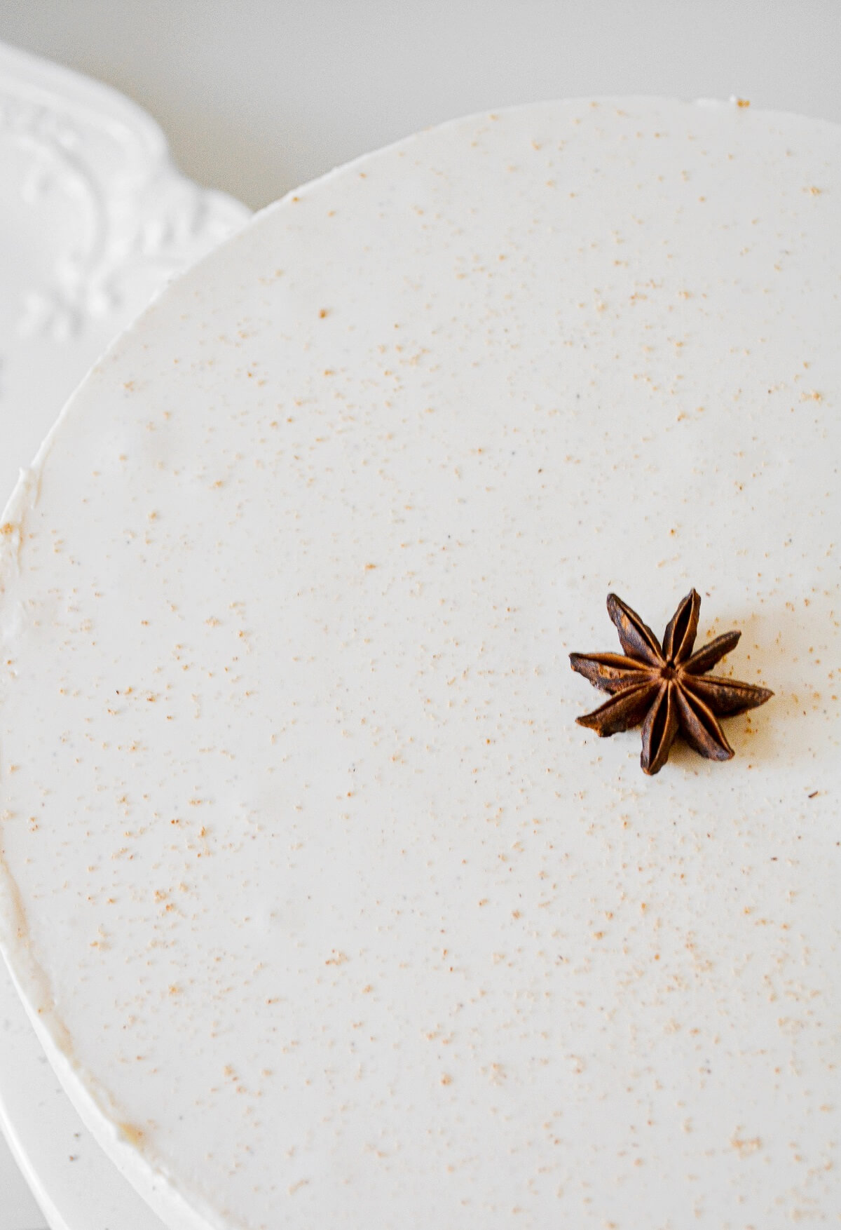 Eggnog cheesecake topped with nutmeg and a star anise.