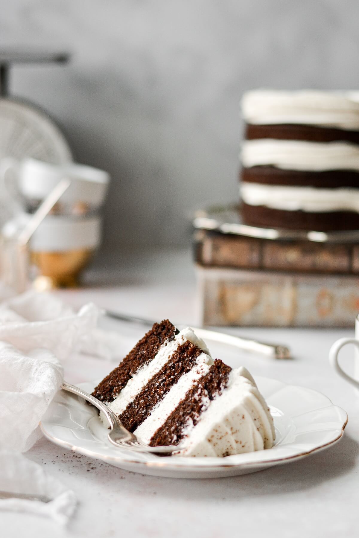 A slice of three layer spice cake with cream cheese buttercream.