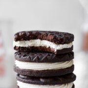 A stack of chocolate sandwich cookies filled with coconut cream frosting.