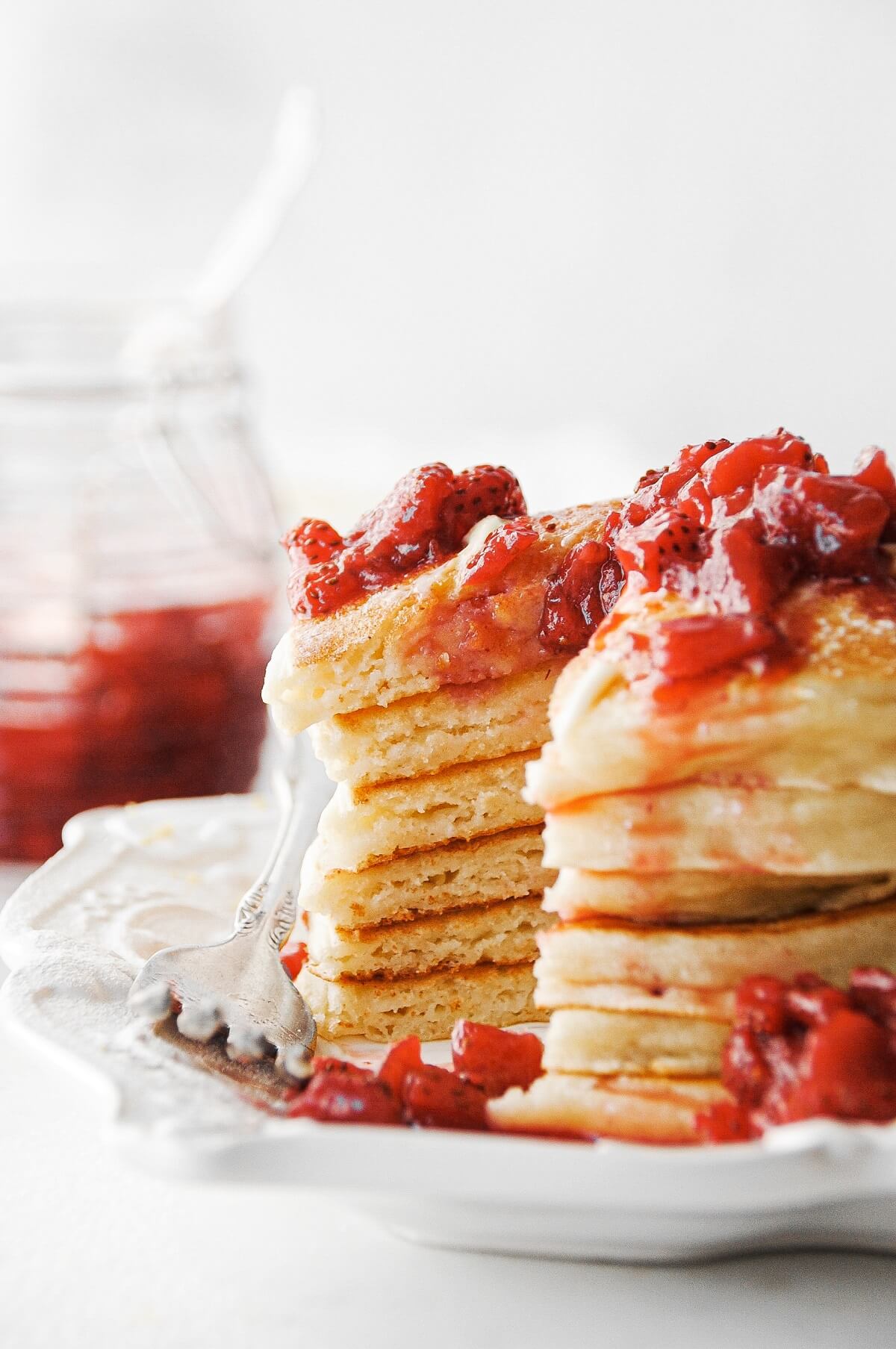 Lemon ricotta pancakes topped with strawberry sauce.