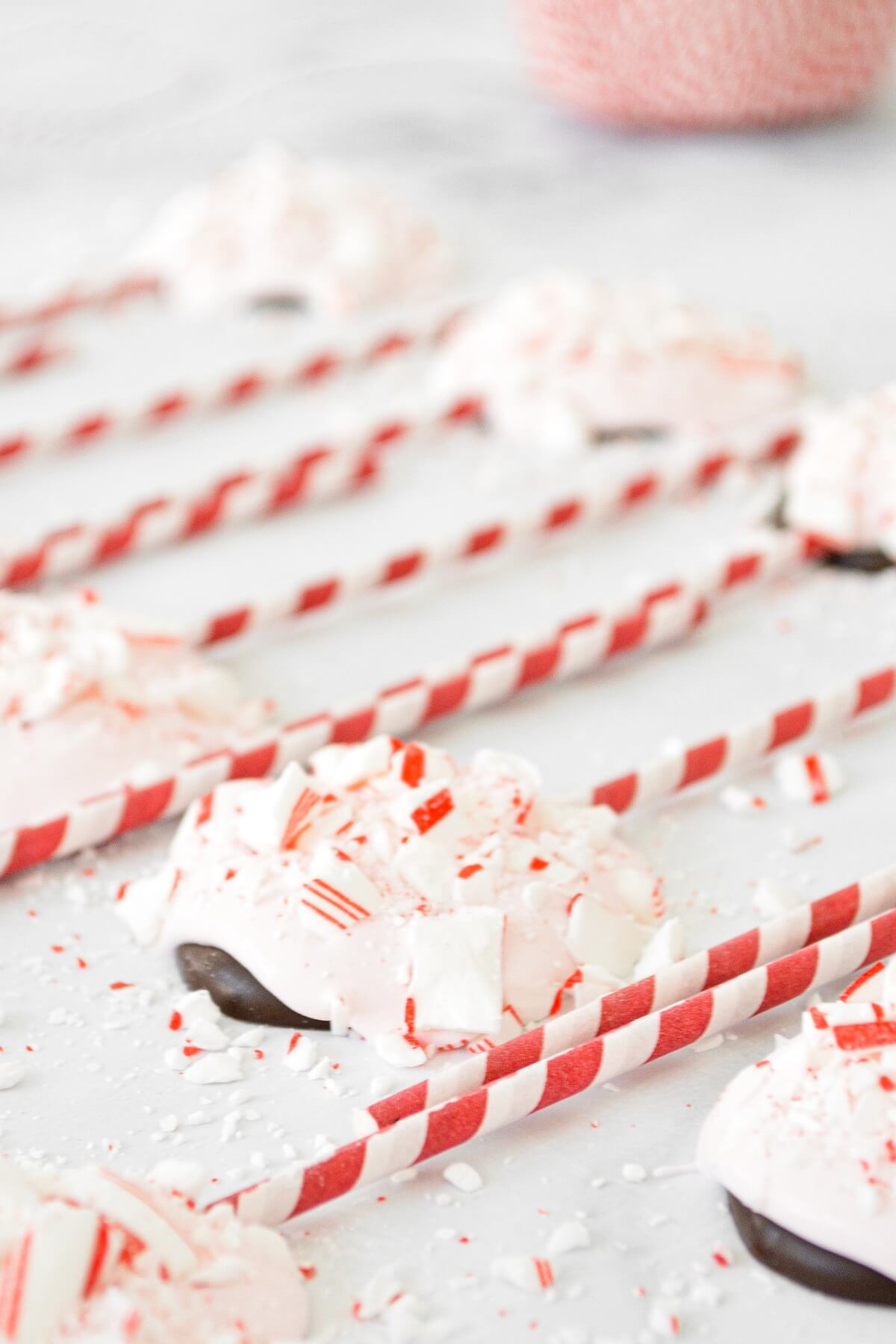 Peppermint bark pops on red and white striped sticks.