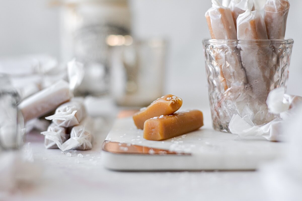 Soft salted caramels on a marble cutting board.
