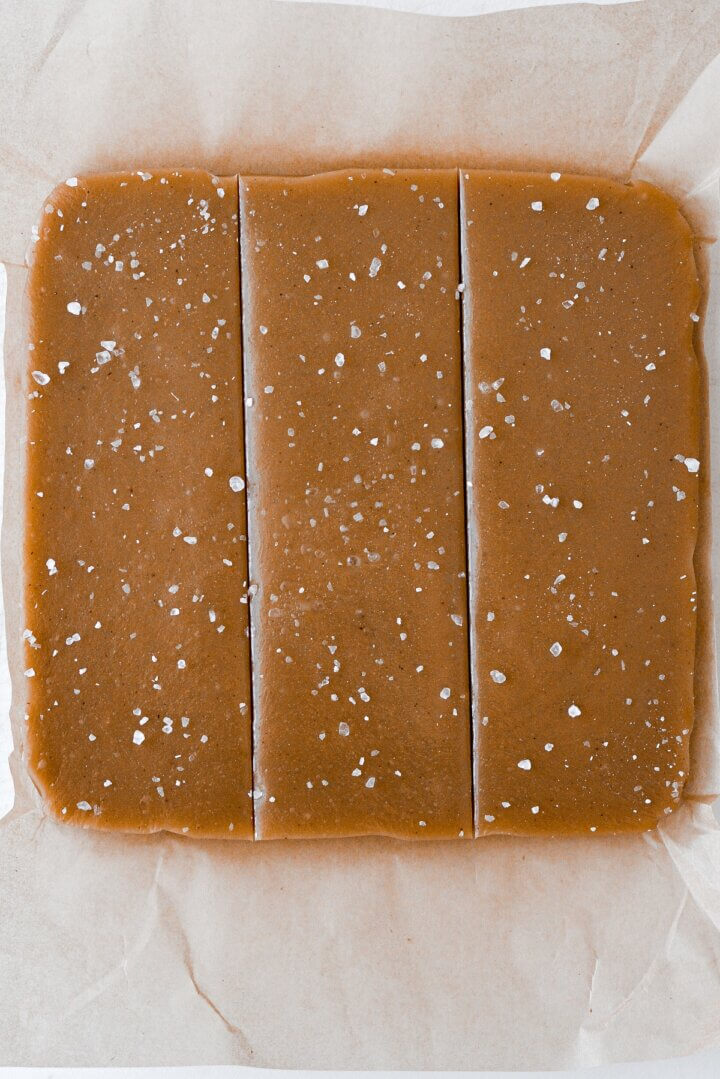 Vanilla salted caramels on wax paper.