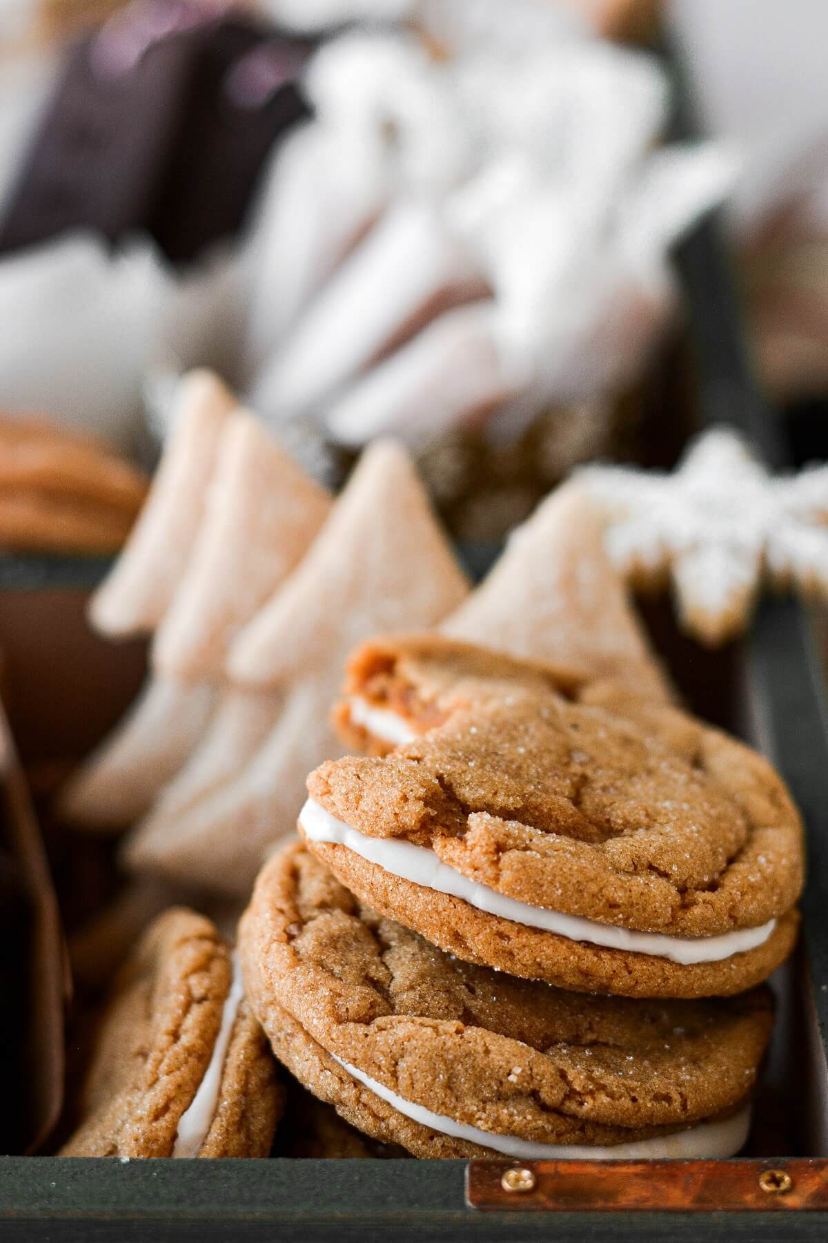 Ginger molasses lemon sandwich cookies in a box of Christmas cookies.