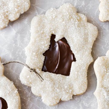 Chocolate hazelnut linzer cookies, with the center cutout in the shape of a mini house.