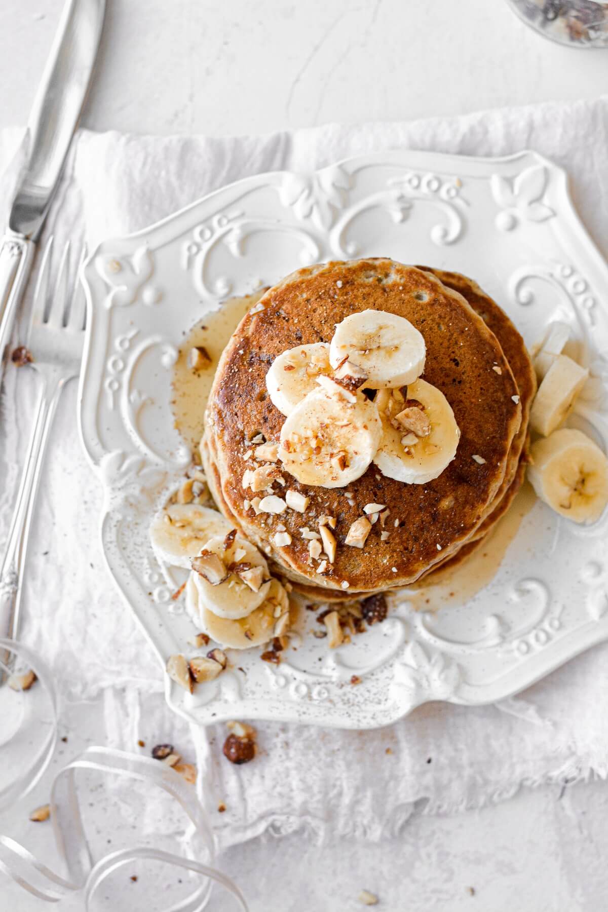 Banana bread pancakes, topped with bananas and almonds.