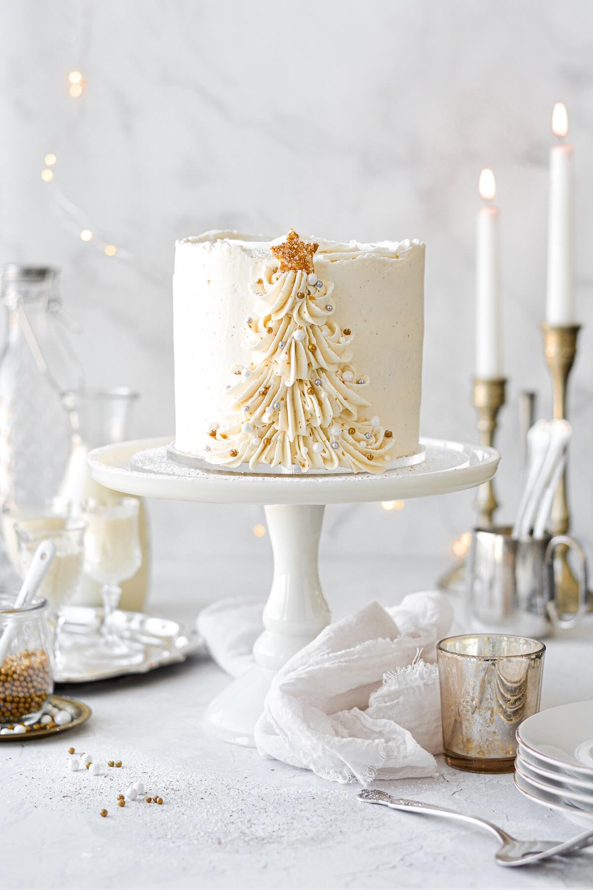 Eggnog cake with a buttercream Christmas tree piped up the side.
