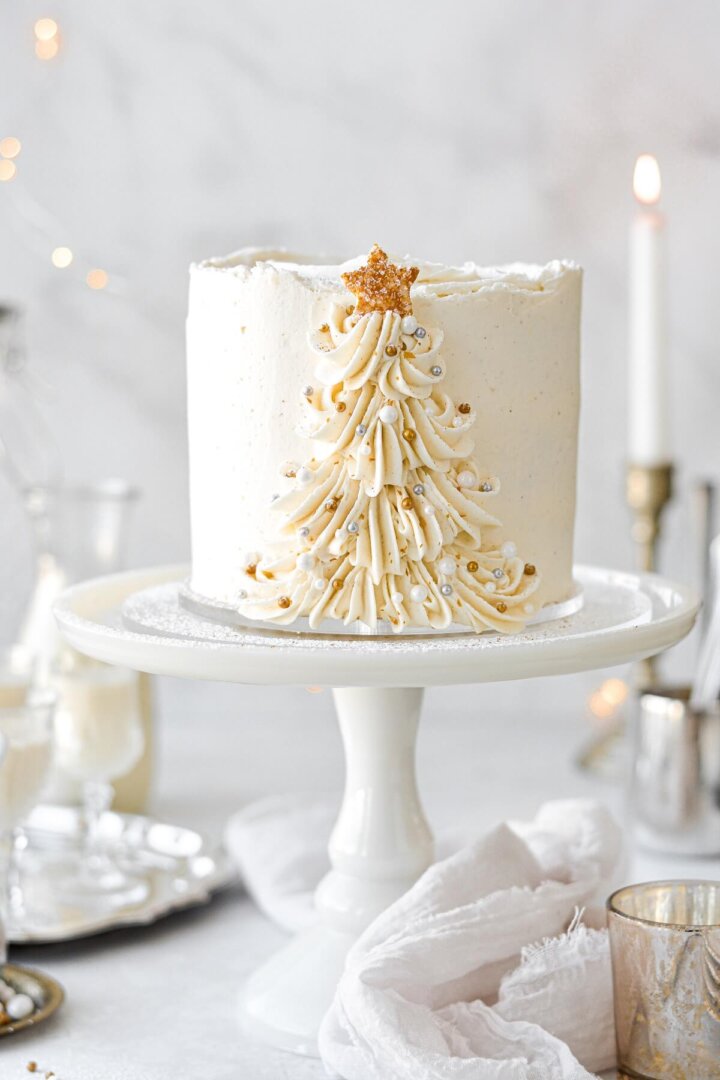 Eggnog cake with a buttercream Christmas tree piped up the side.