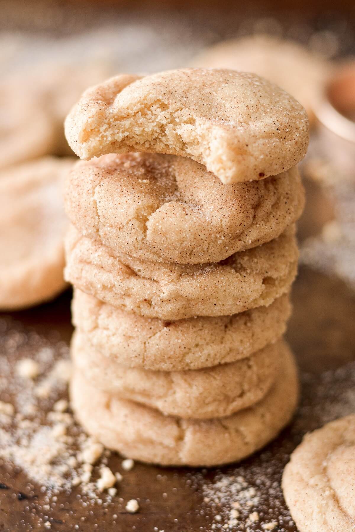 A stack of high alititude snickerdoodles, one with a bite taken out of it.