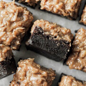 German chocolate bourbon brownies on a marble serving board.