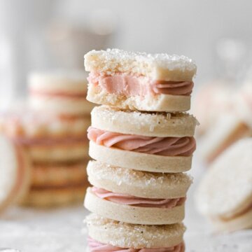 A stack of vanilla raspberry sandwich cookies.