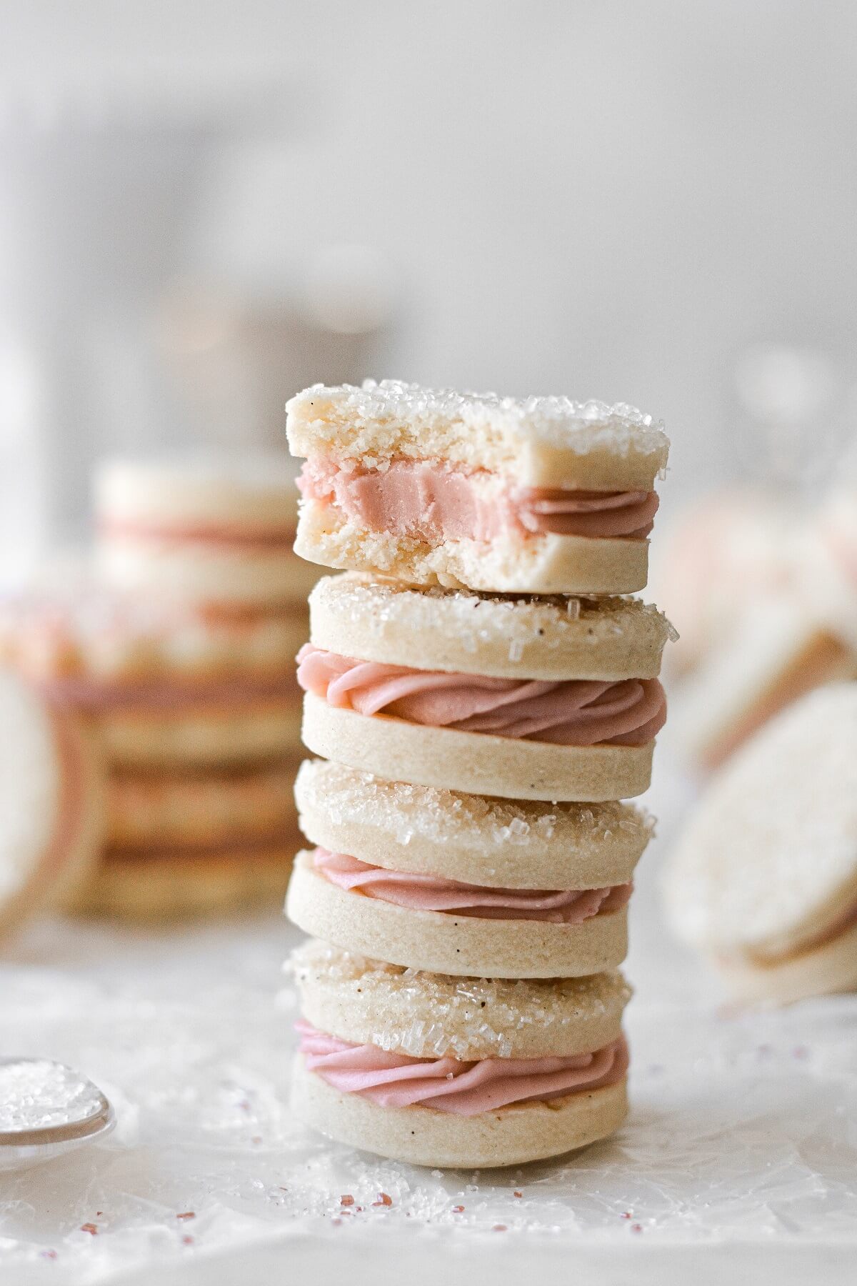 A stack of vanilla raspberry sandwich cookies.