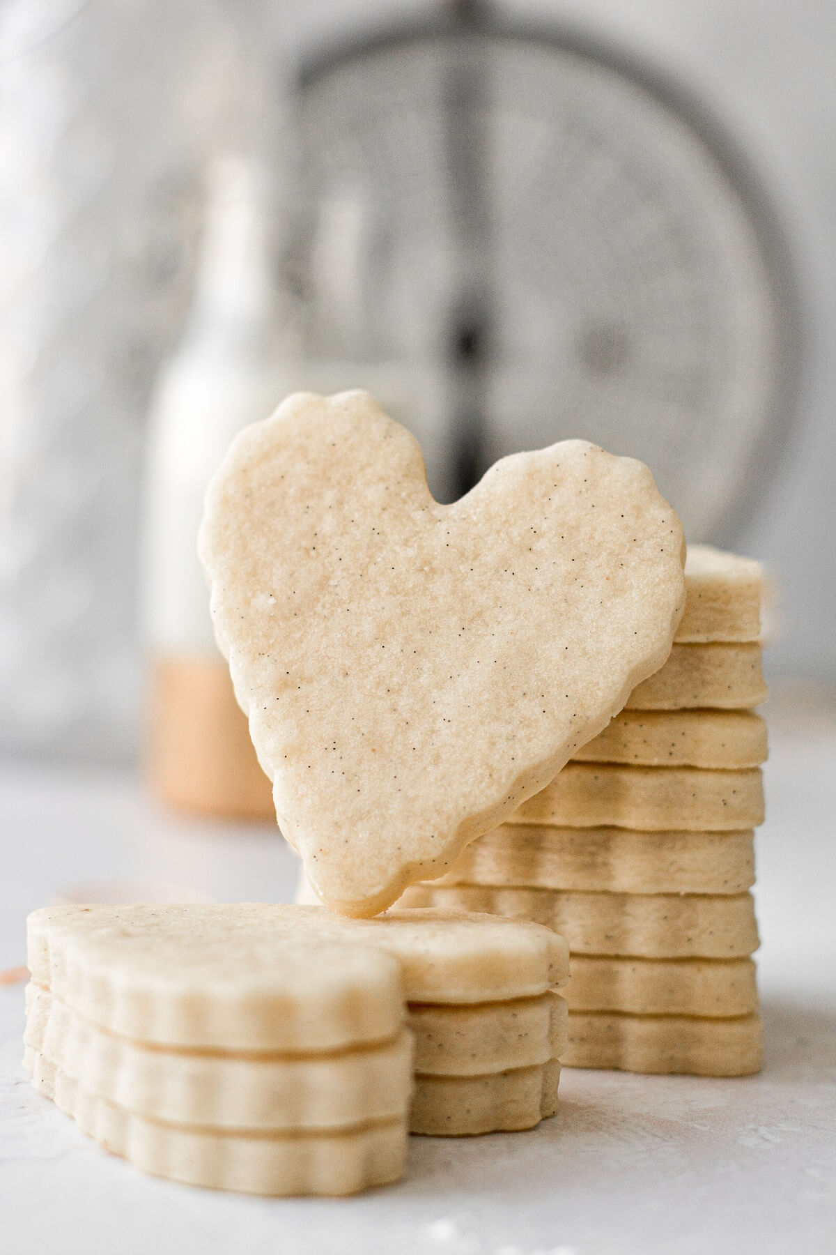 A stack of heart shaped vanilla bean sugar cookies.