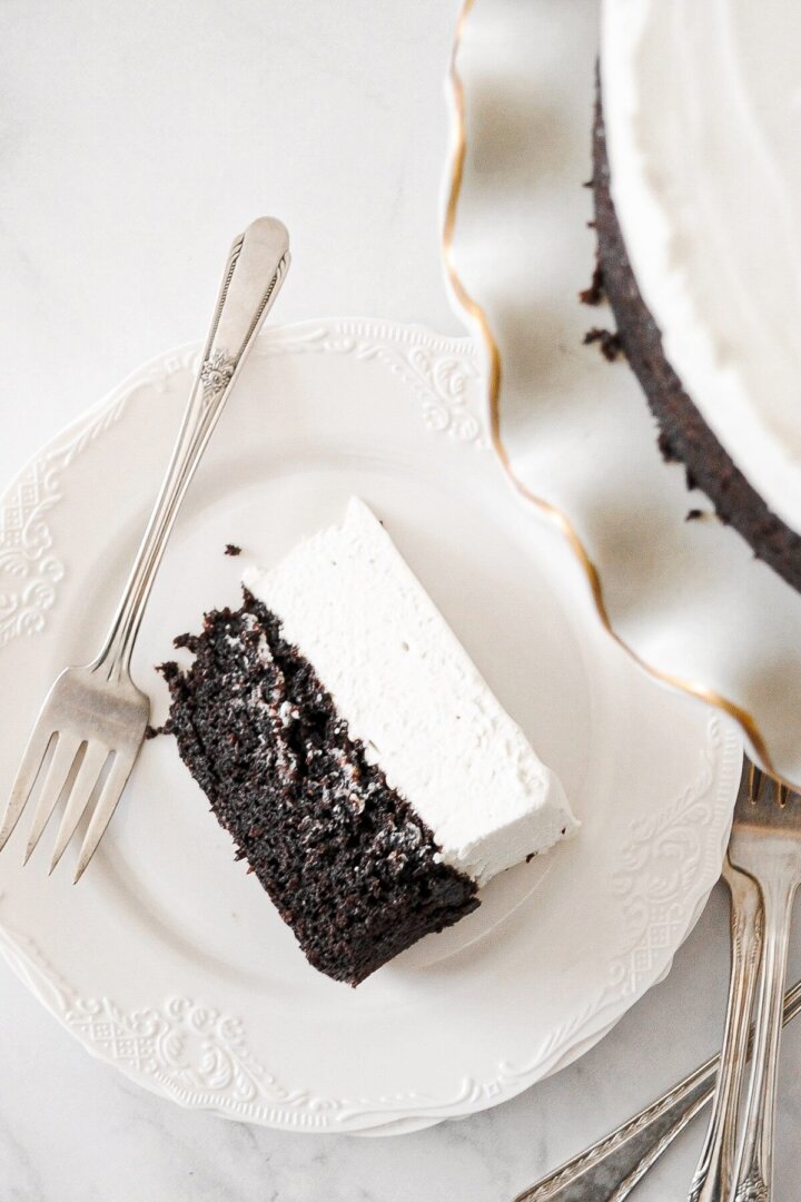A slice of black and white cheesecake on a white plate.