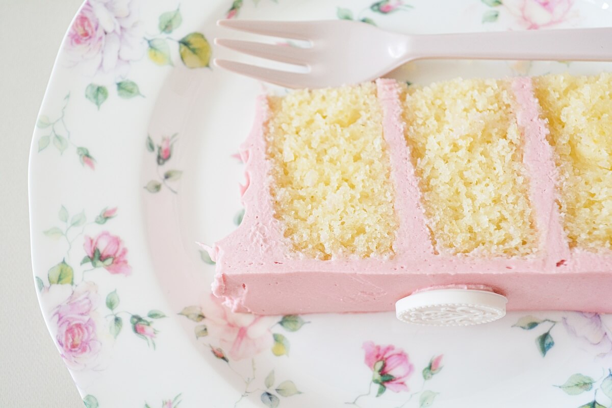 A slice of lemon raspberry cake on a flowered plate.