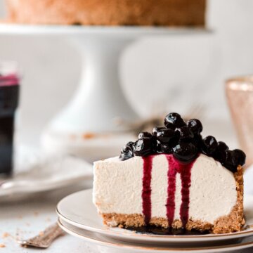 A piece of no bake vanilla cheesecake with blueberry sauce.