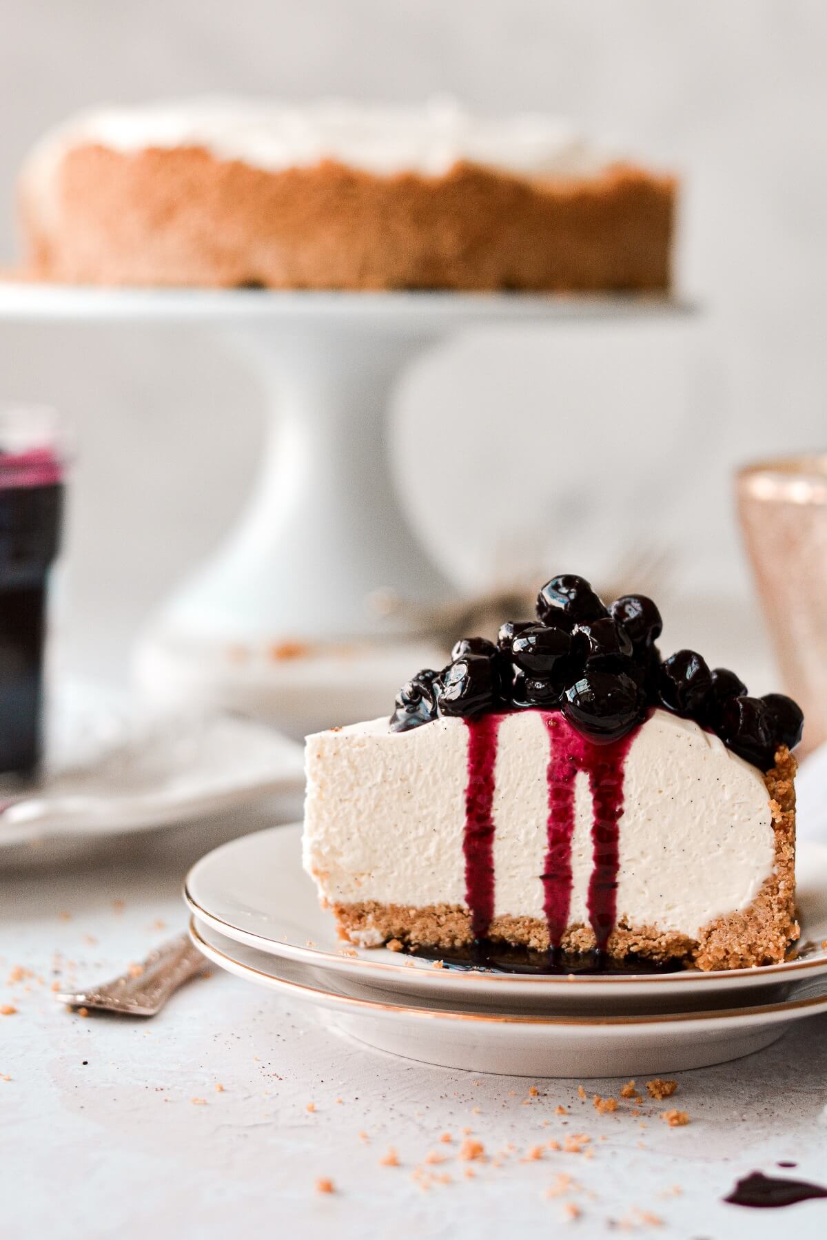 A piece of no bake vanilla cheesecake with blueberry sauce.