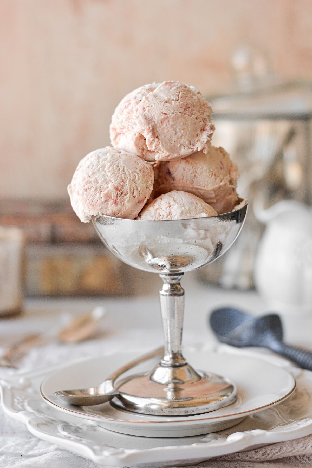 Scoops of roasted rhubarb ice cream in a silver bowl.