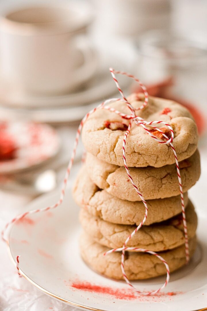 A stack of strawberry brown butter cookies tied with red and white twine.
