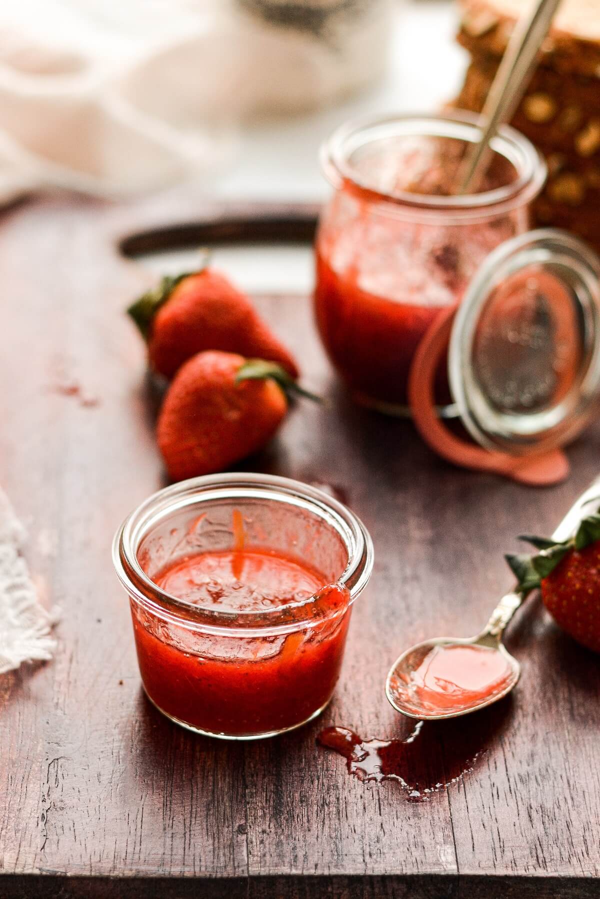 Glass jars filled with strawberry rhubarb jam.