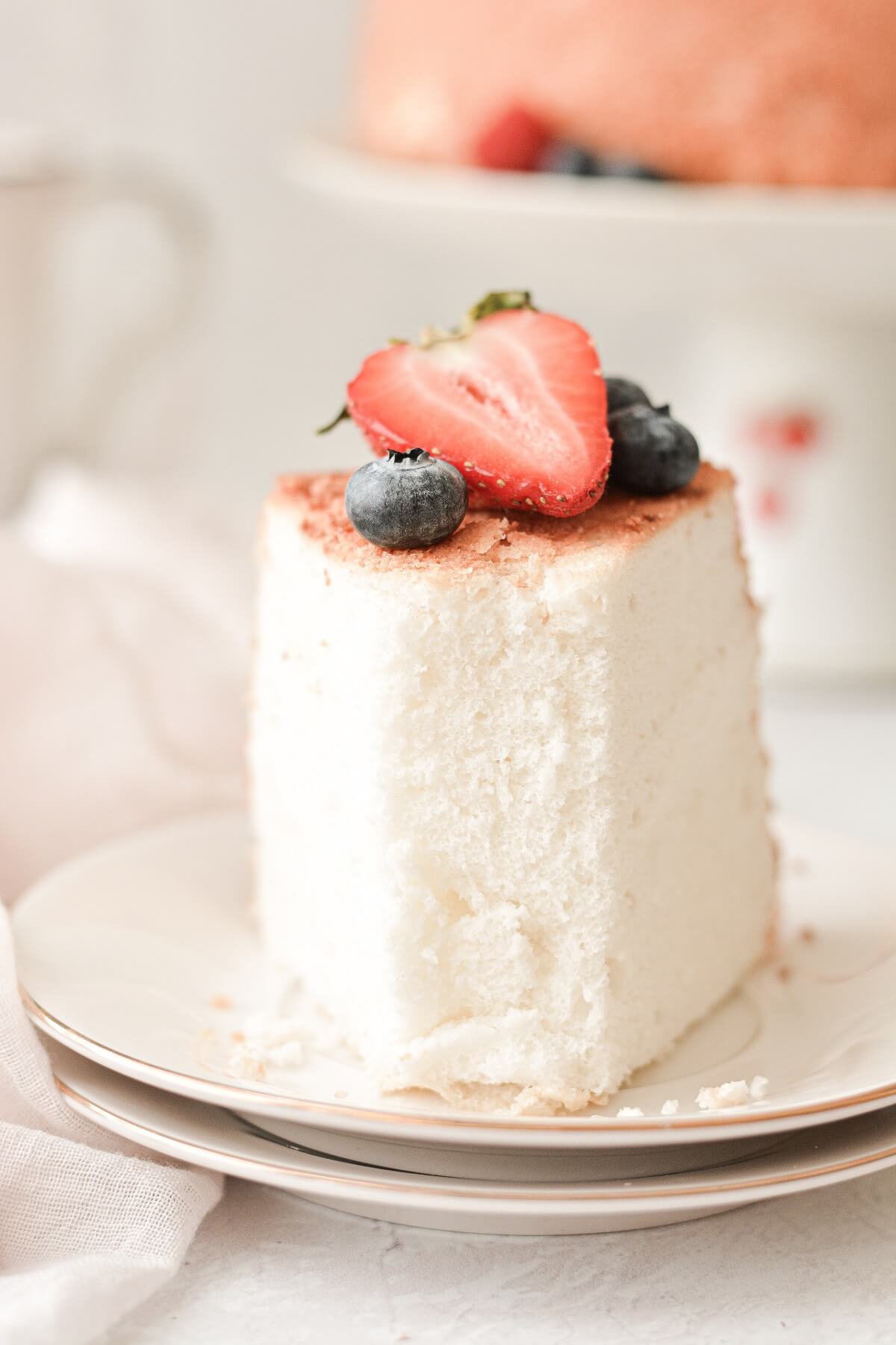A slice of angel food cake topped with berries.