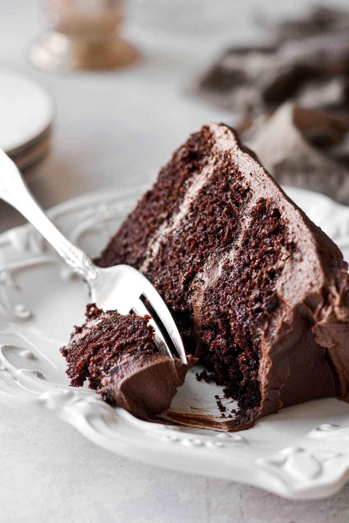 A slice of chocolate cake with chocolate buttercream.