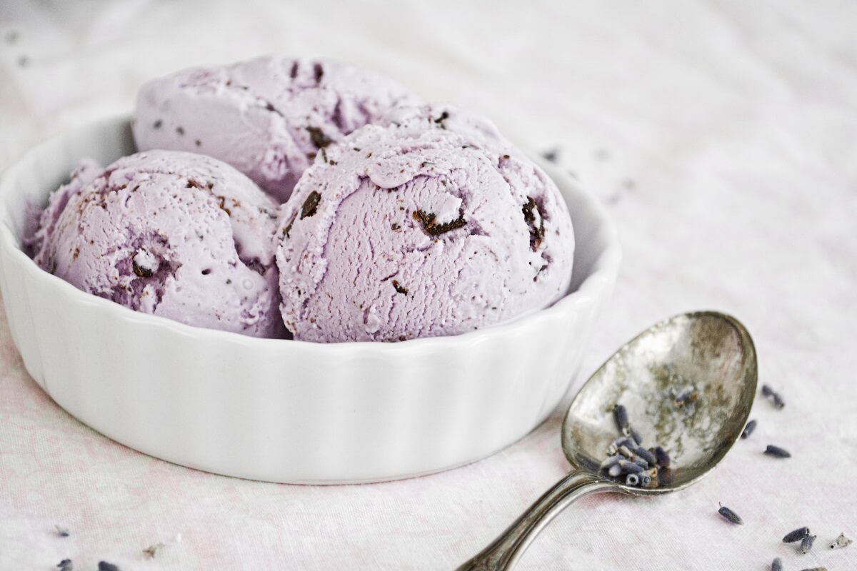 Scoops of lavender honey ice cream with chocolate chips.