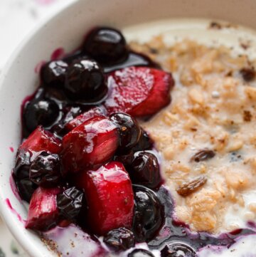 A bowl of oatmeal topped with blueberry rhubarb compote.