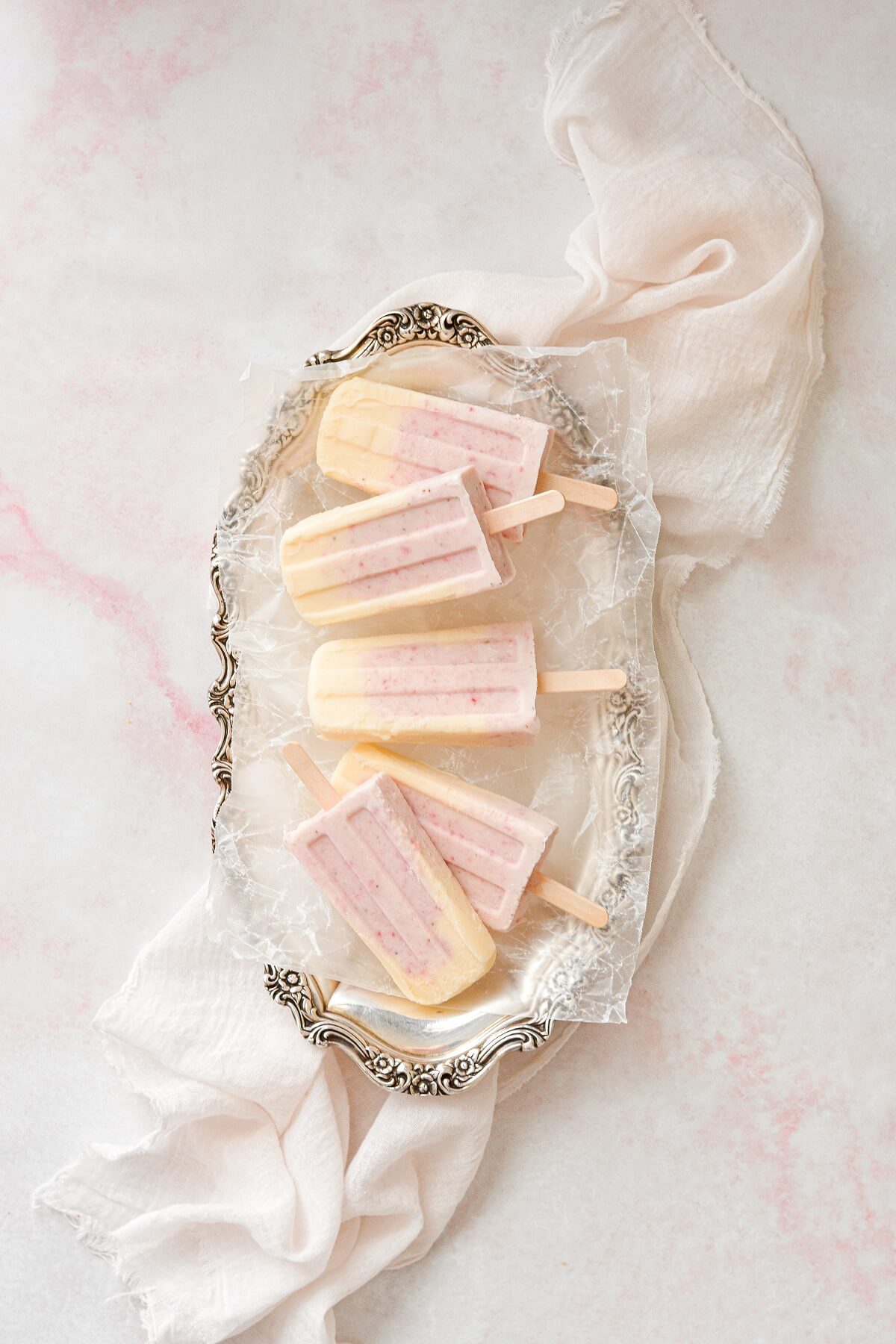 Strawberry orange creamsicles, arranged on a silver platter.