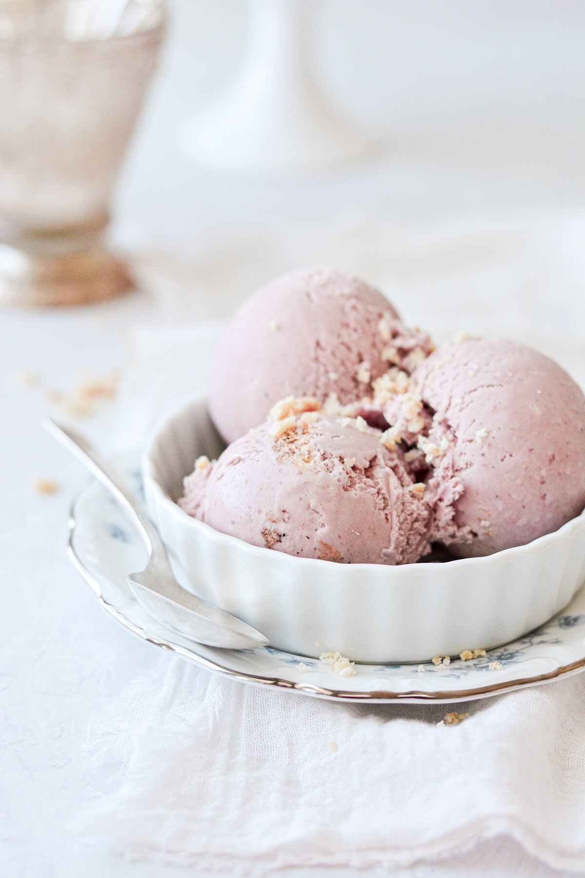 Three scoops of blackberry pie ice cream sprinkled with crumbled pie crust.