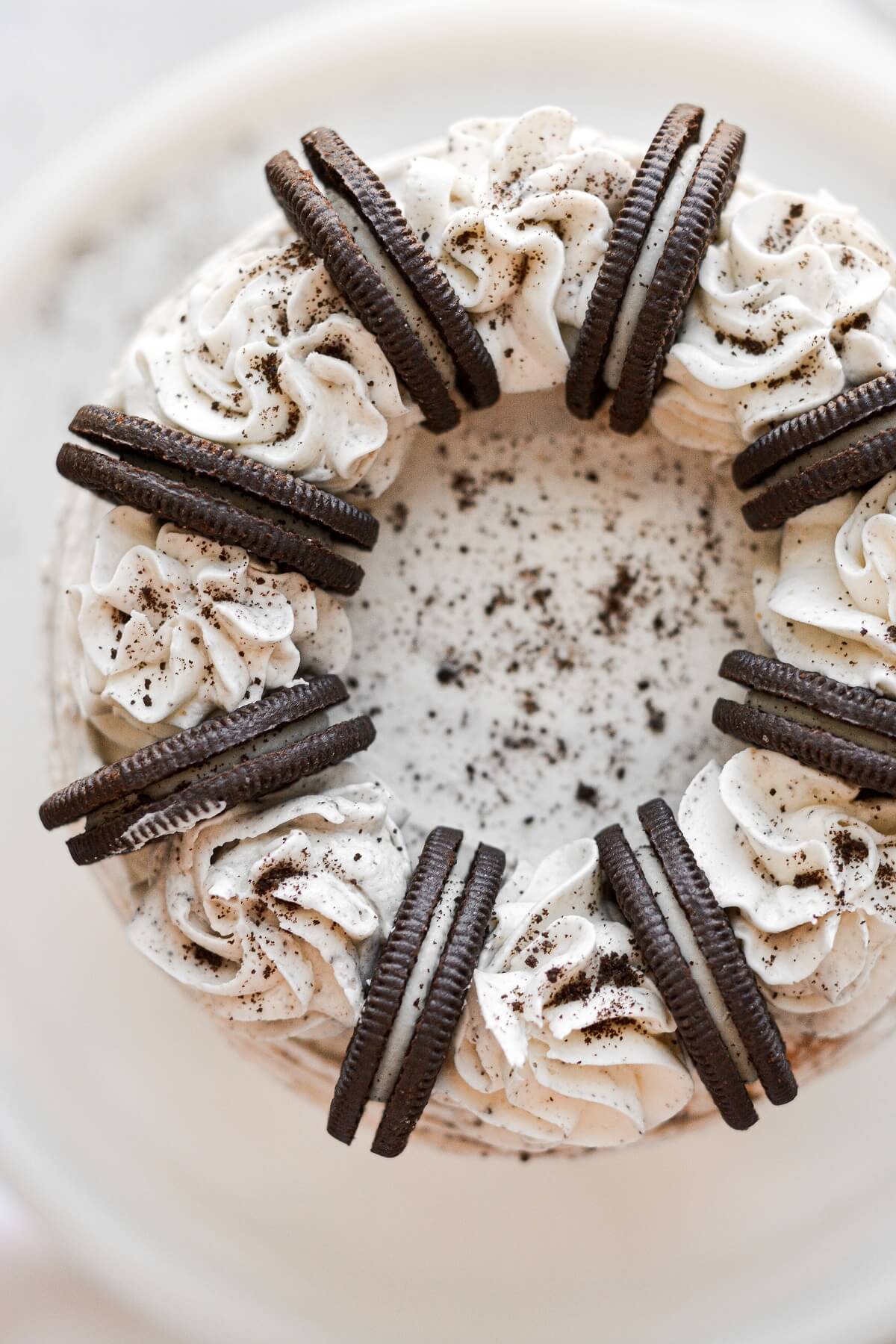 Cookies and cream cake, topped with Oreos and buttercream swirls.