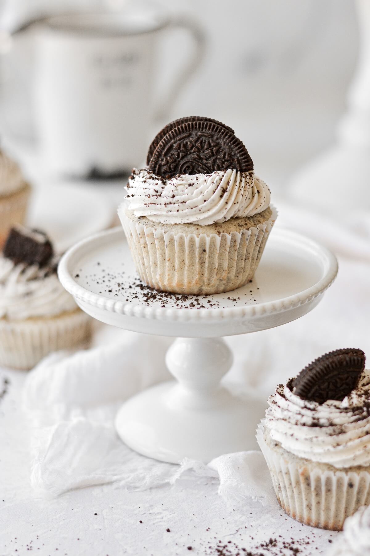 Cookies and cream cupcakes topped with Oreos.