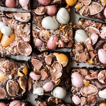 Mini cadbury egg Easter brownies, cut into squares on a white platter.