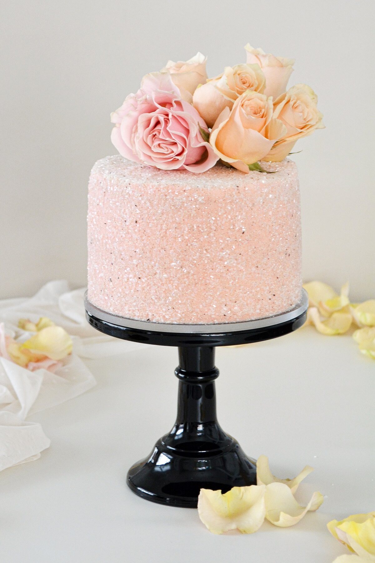 Chocolate peppermint cake, covered in pink sparkling sugar and pink and peach roses.