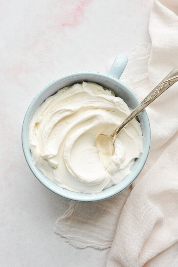 A bowl of whipped cream cheese.