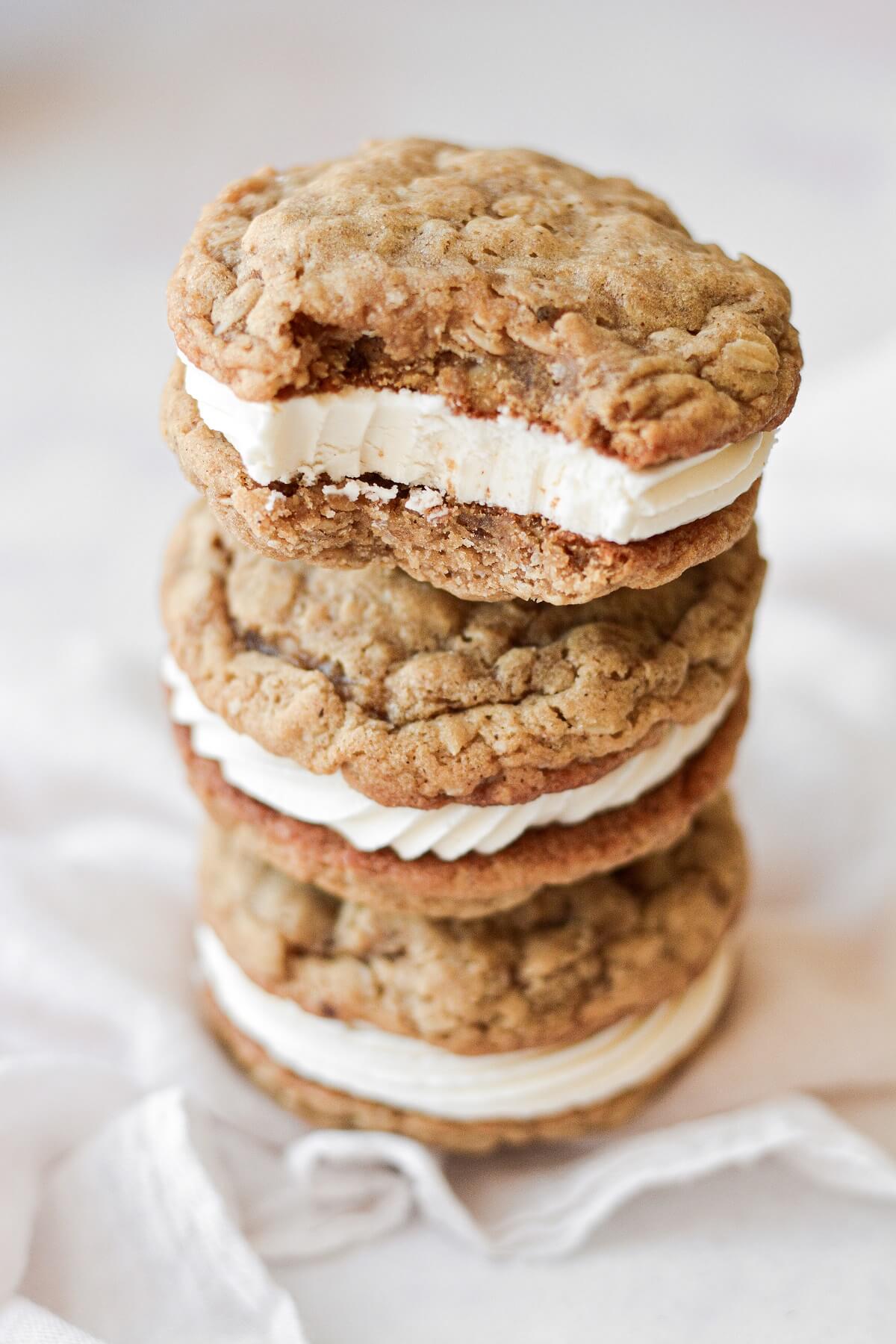 Homemade oatmeal cream pies, one with a bite taken.