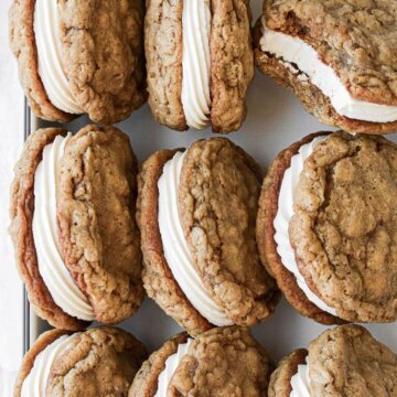 Homemade oatmeal cream pies in a tray.