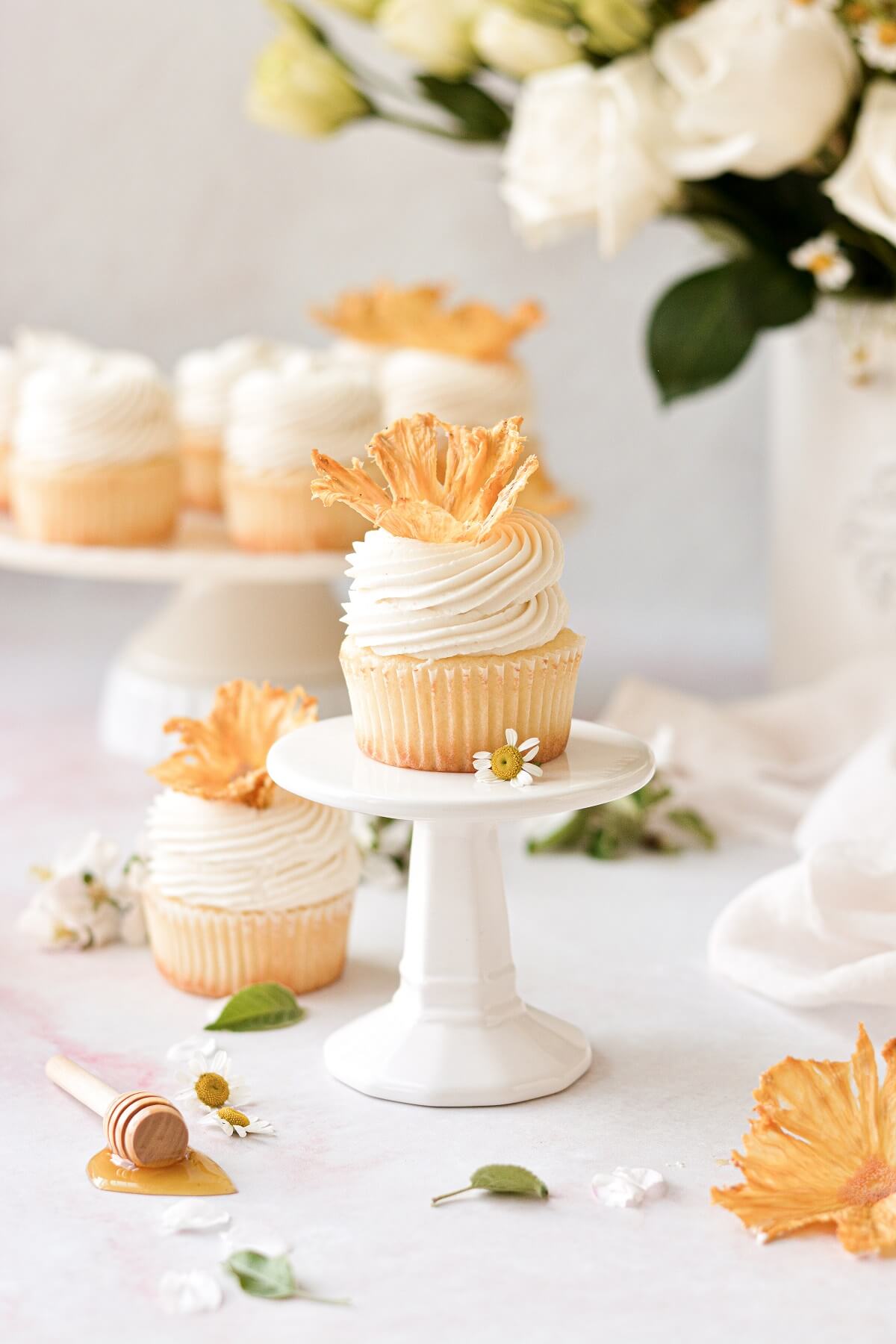 Honey lemon cupcakes topped with dried pineapple flowers.