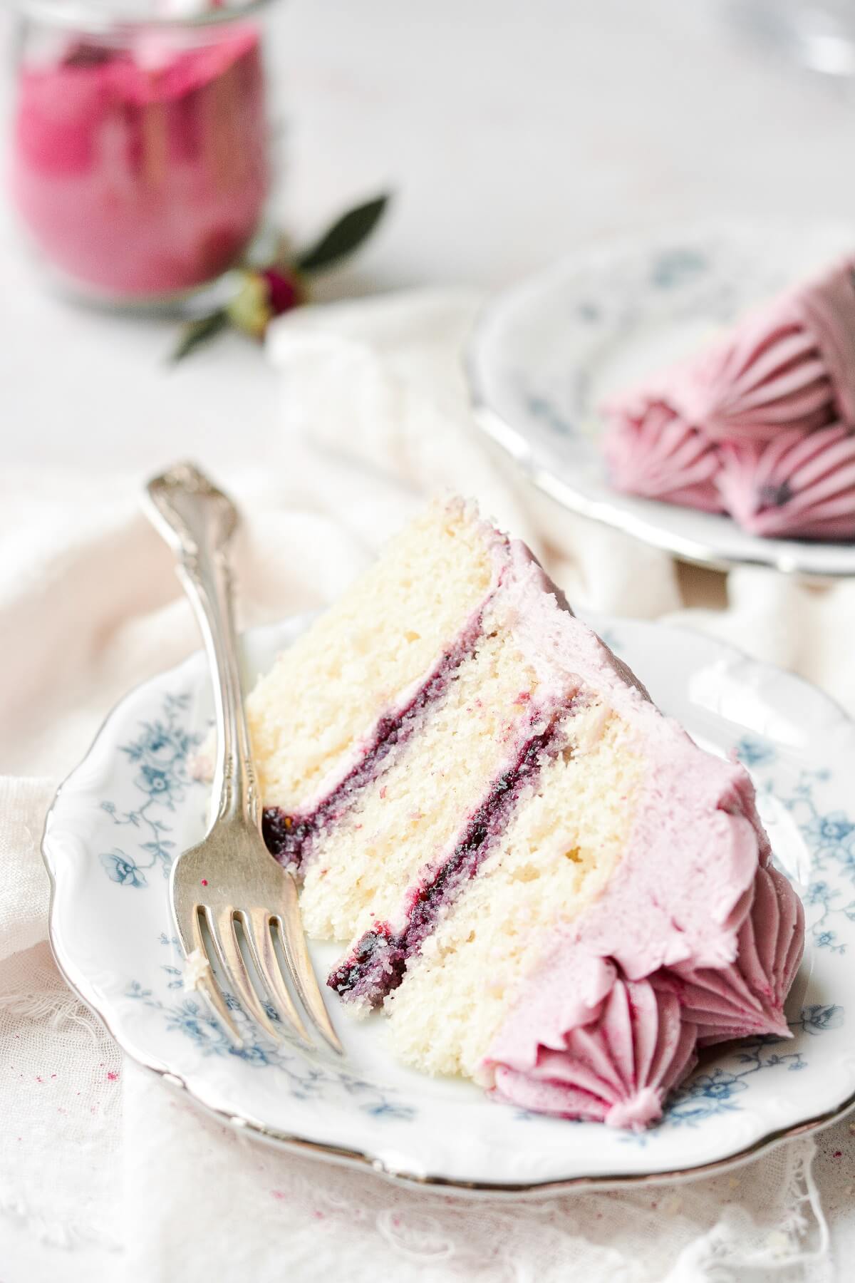 Slices of vanilla cake with blueberry jam filling and blueberry buttercream.