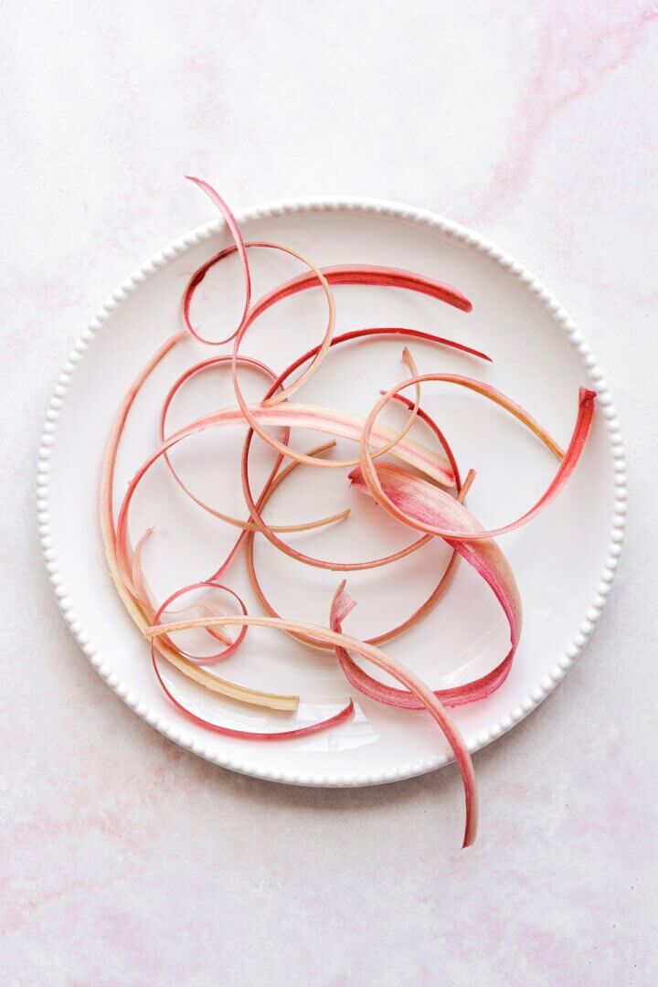 Strips of thinly sliced rhubarb on a plate.