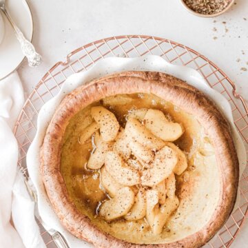 A Dutch baby pancake filled with cinnamon apples and crushed pecans.