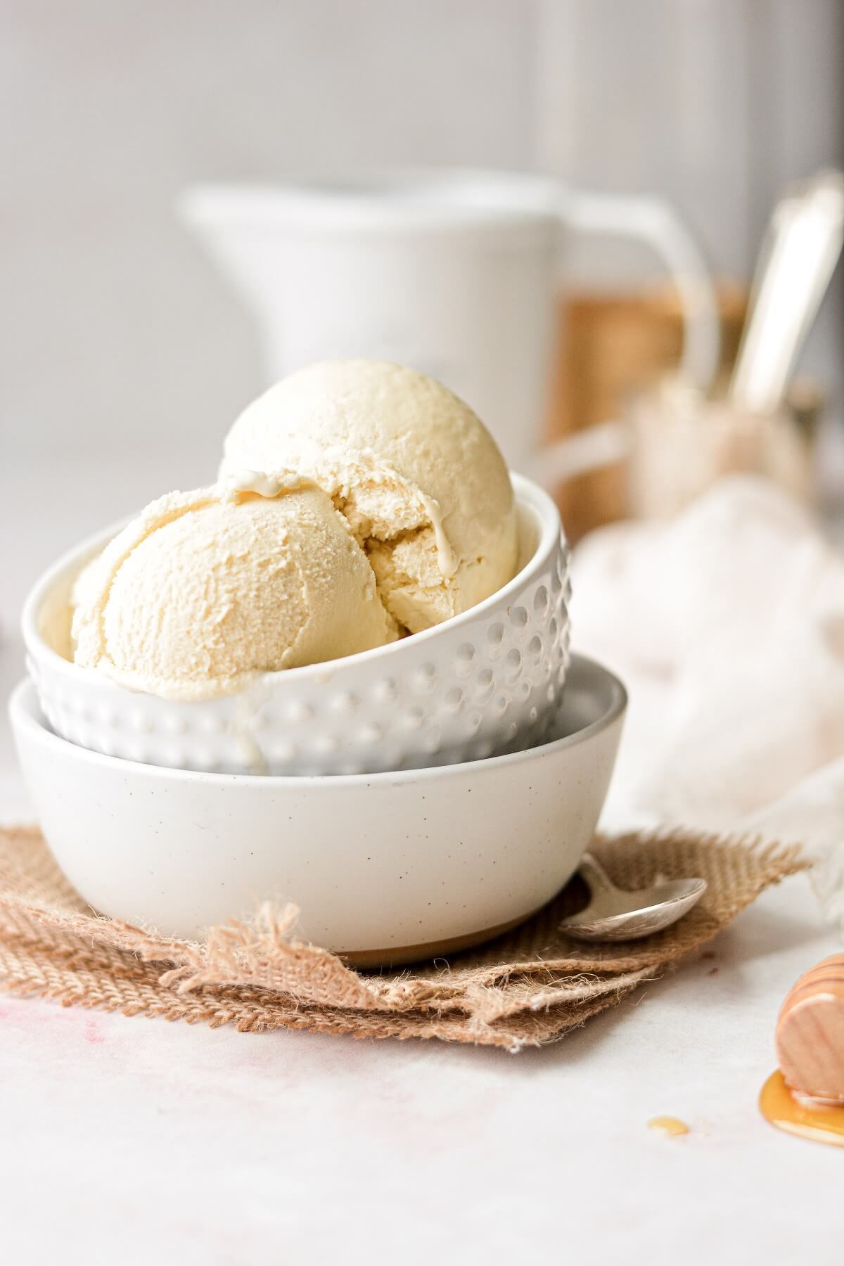 A stack of white bowls, filled with scoops of salted honey ice cream.