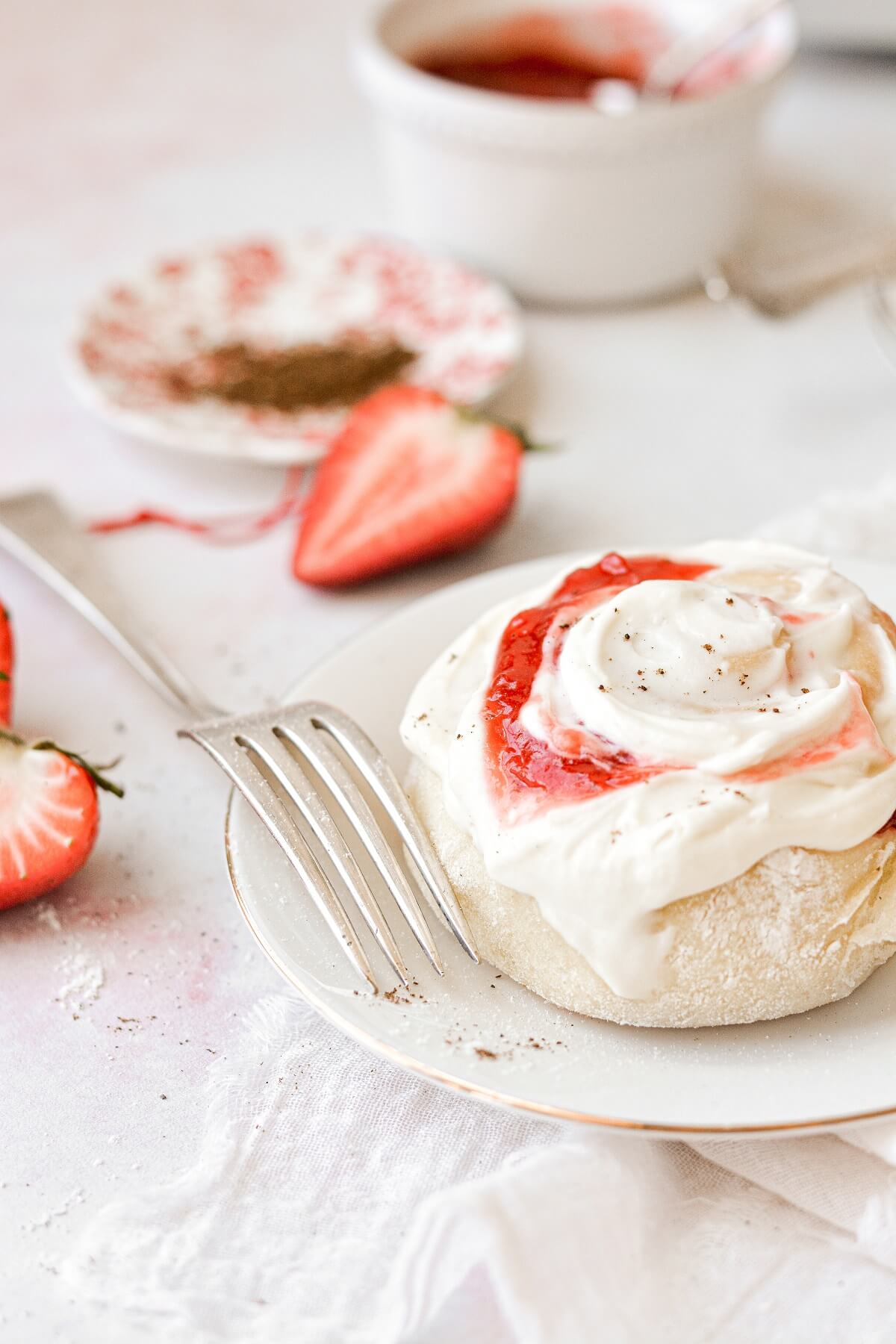 A strawberry roll with cream cheese frosting.
