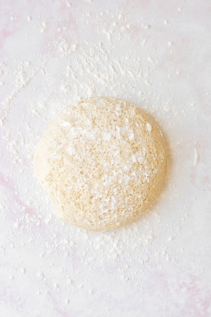 Dough on a counter, sprinkled with flour.