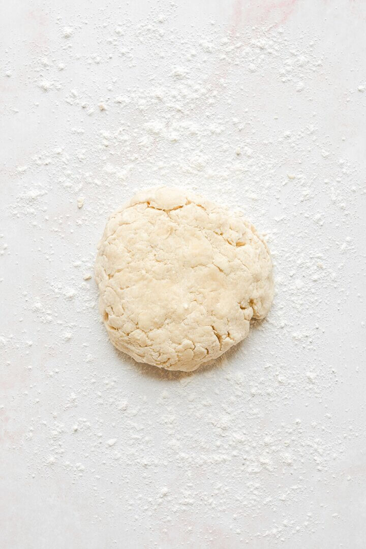 Pie dough, sprinkled with flour and ready to be rolled out.
