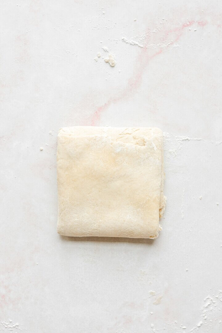 The process of folding pie dough.