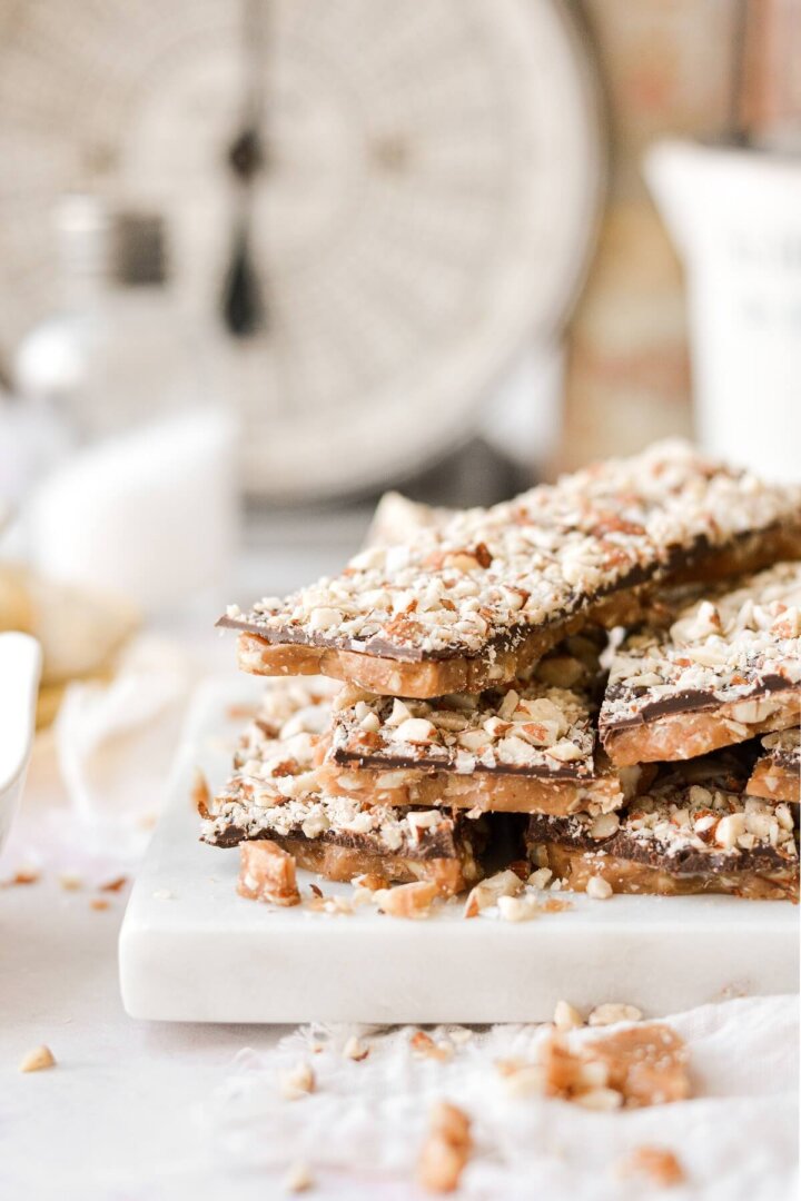 Bars of English toffee stacked on a marble board.