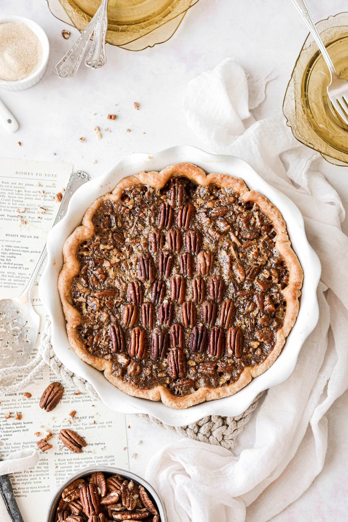 A pecan pie with pecans arranged like a Christmas tree on top of the pie.