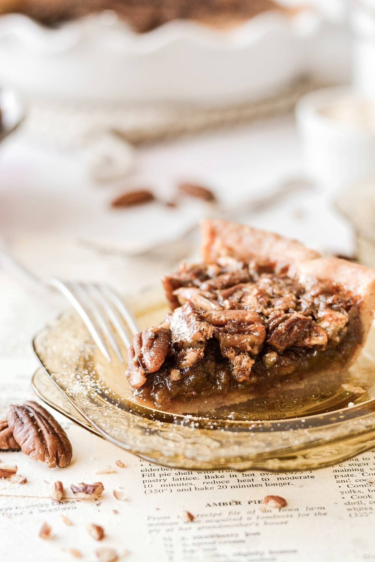 A slice of pecan pie on a yellow glass plate.